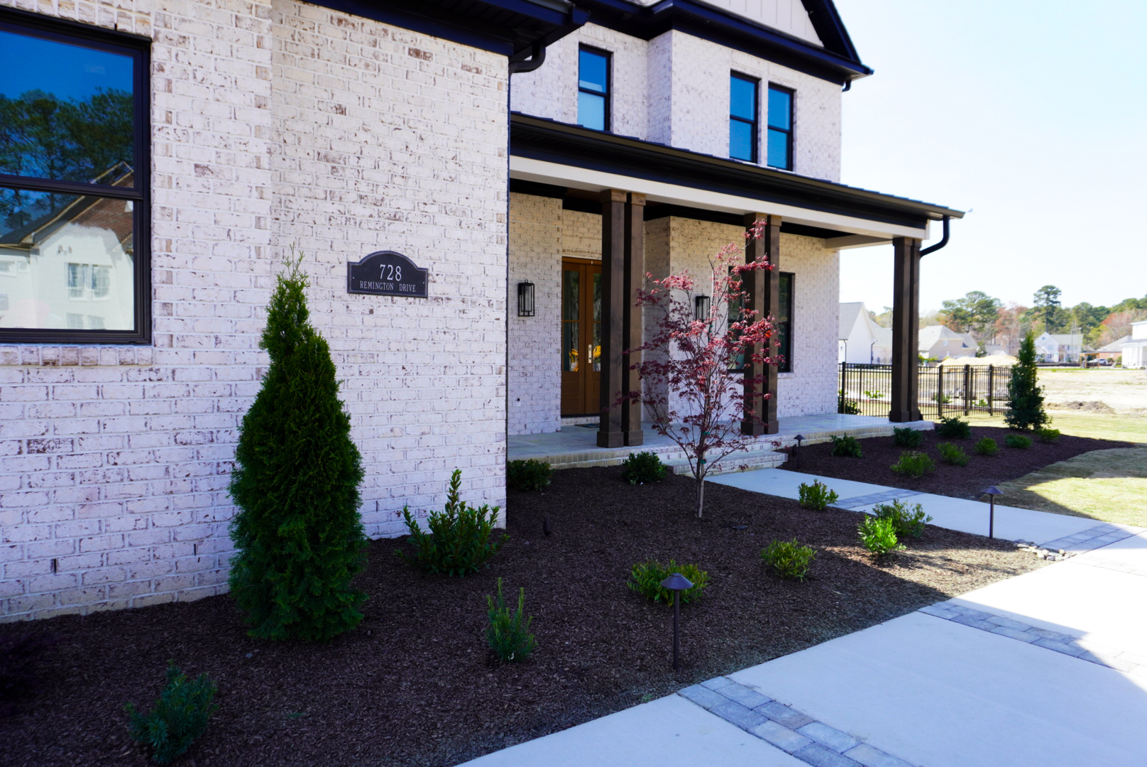 Brick farmhouse — front corner elevation.