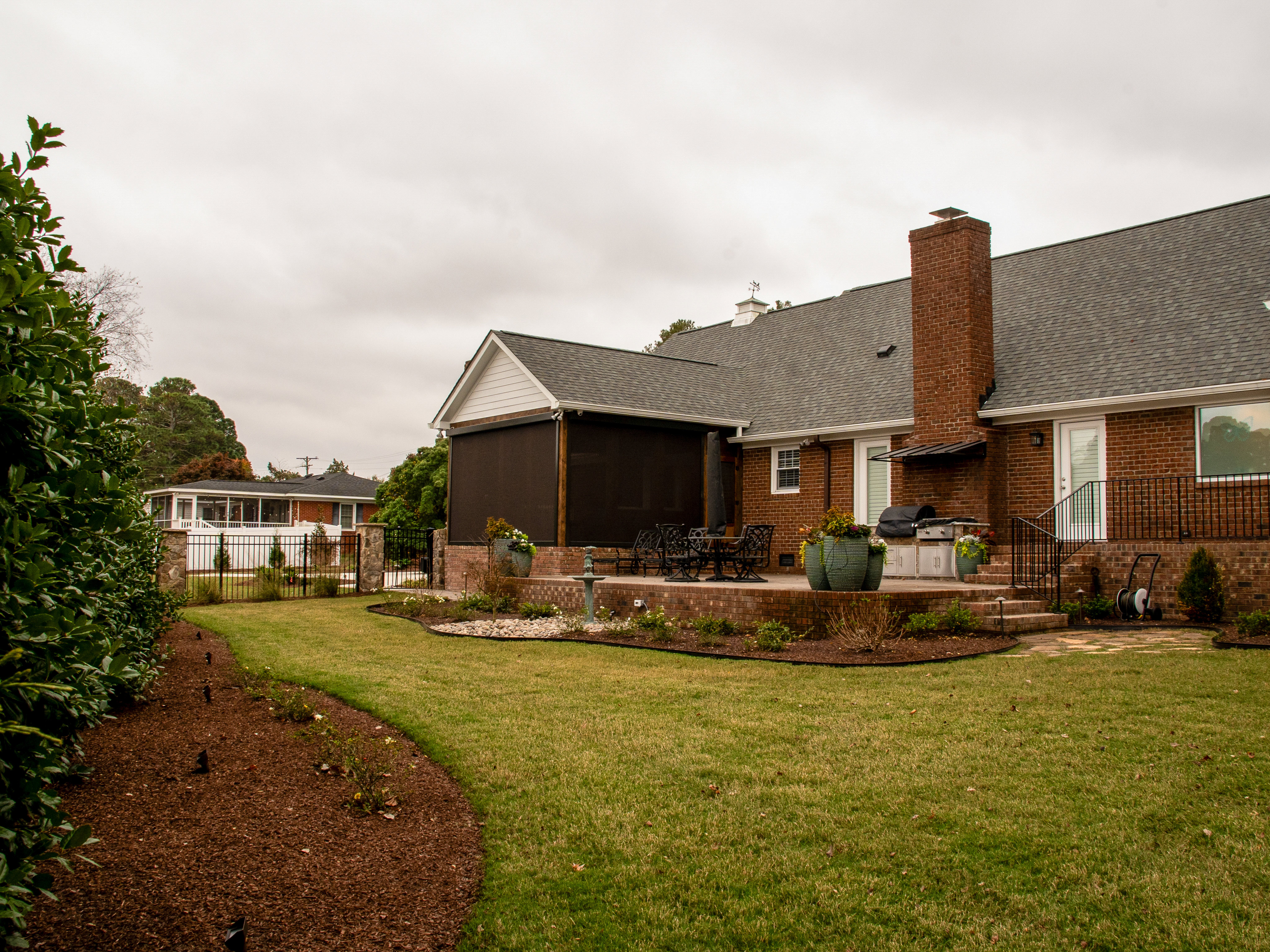 Brick rear elevation with screened porch.