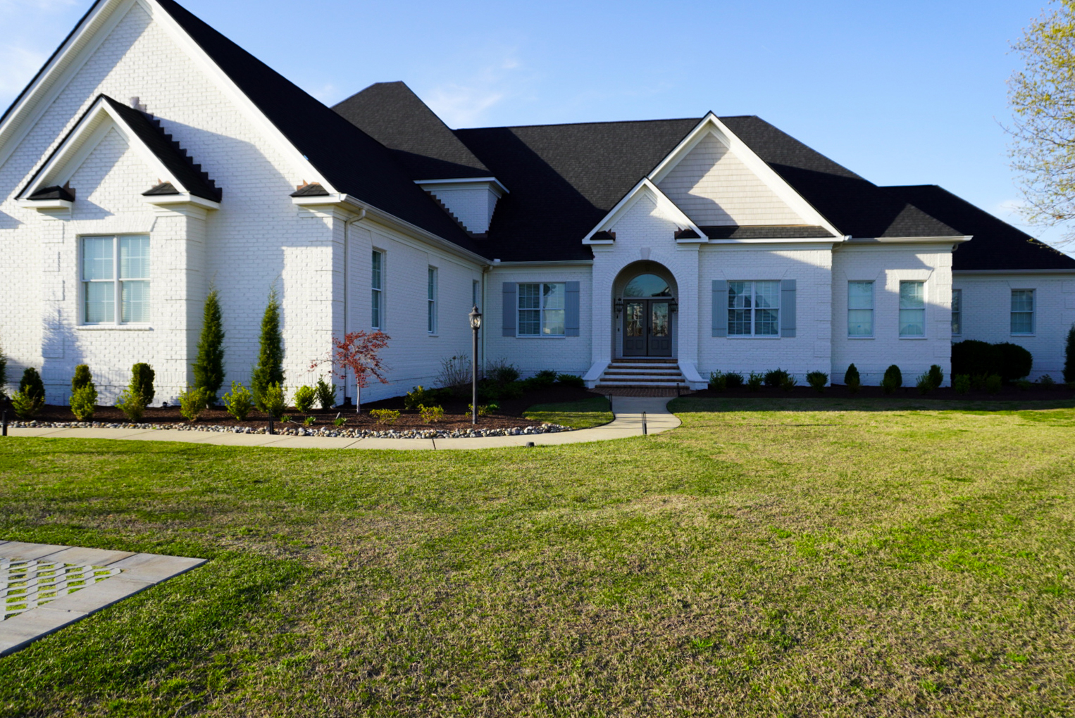 White-brick Southern formal home — front elevation.