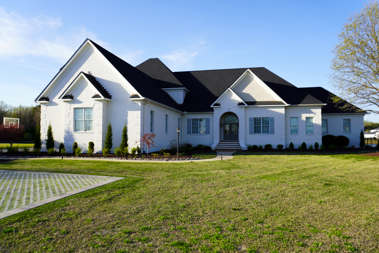 White-brick Southern formal home — side-front elevation.