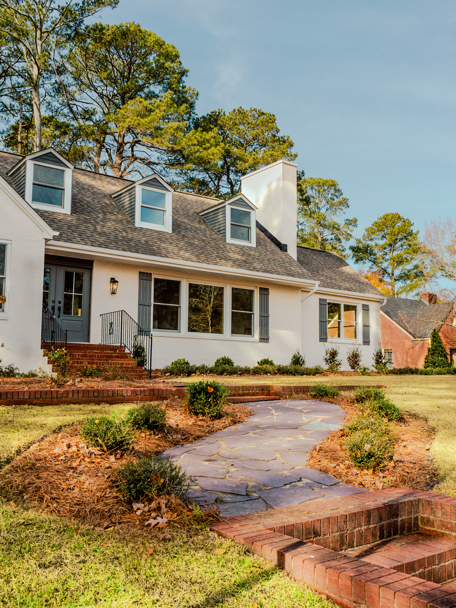 White cottage with flagstone walkway.