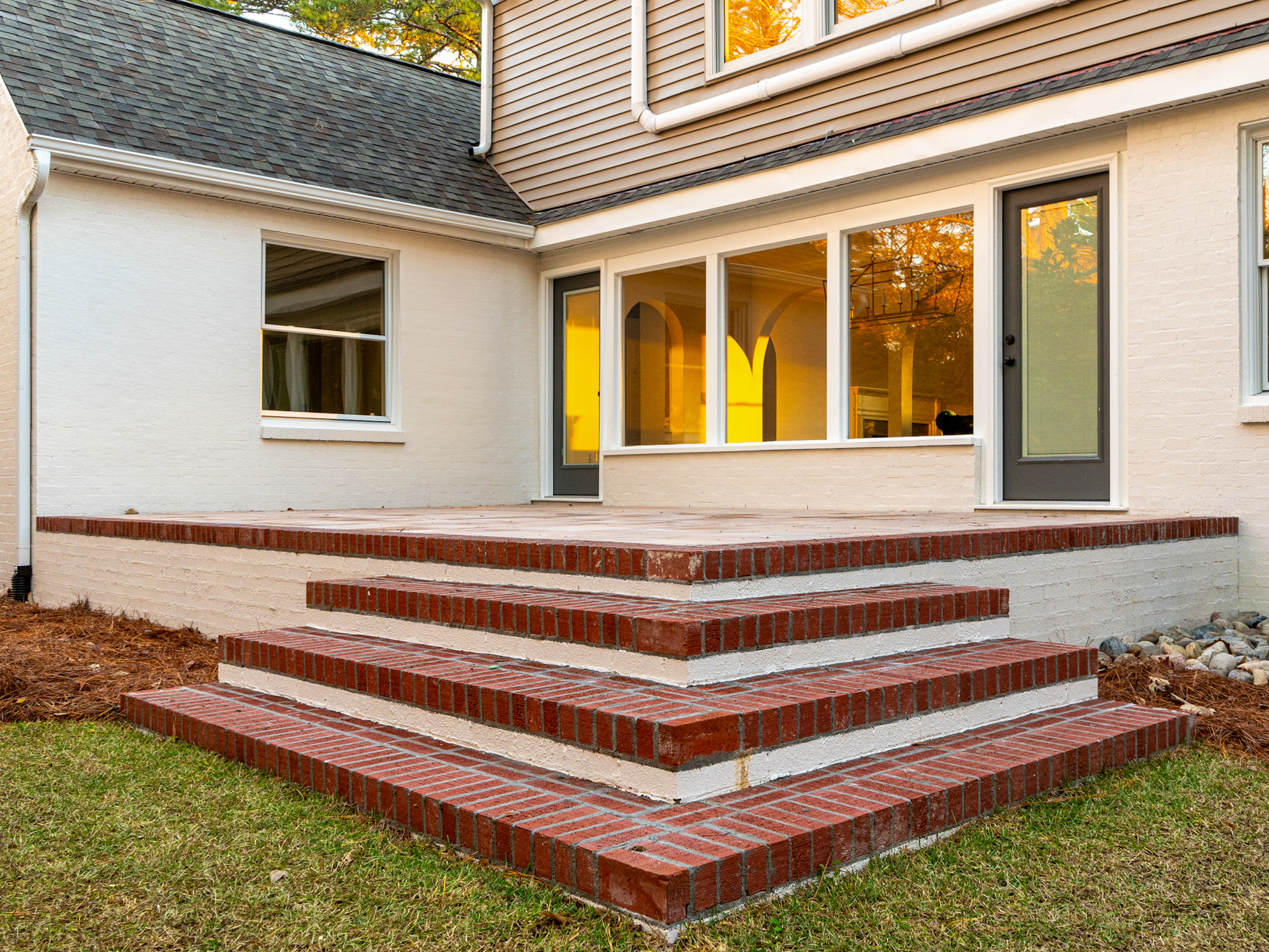Brick back steps leading to french doors.