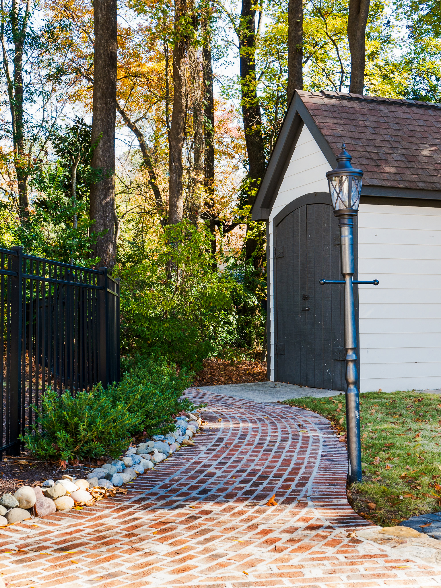 Brick walkway with shed lantern.