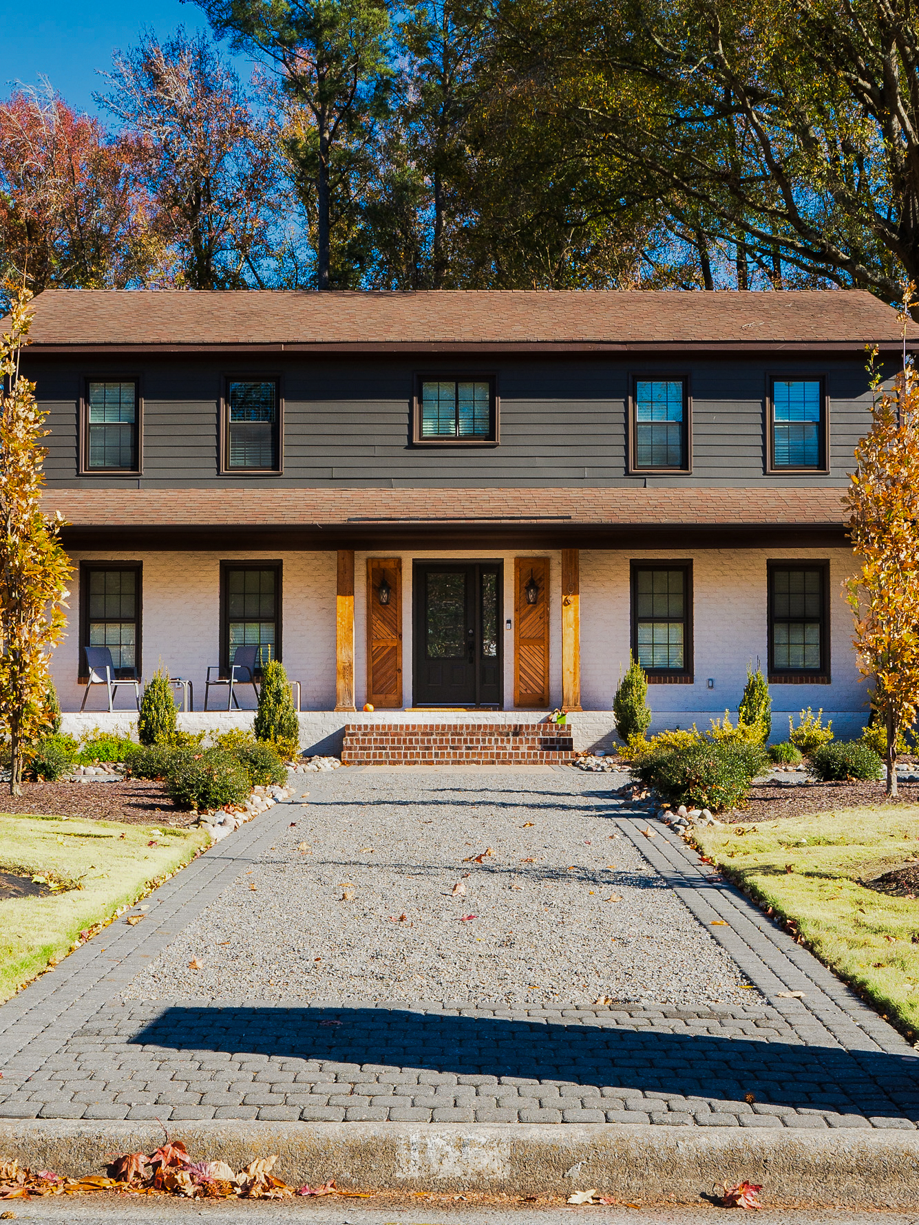 Colonial home with a brick paver driveway.