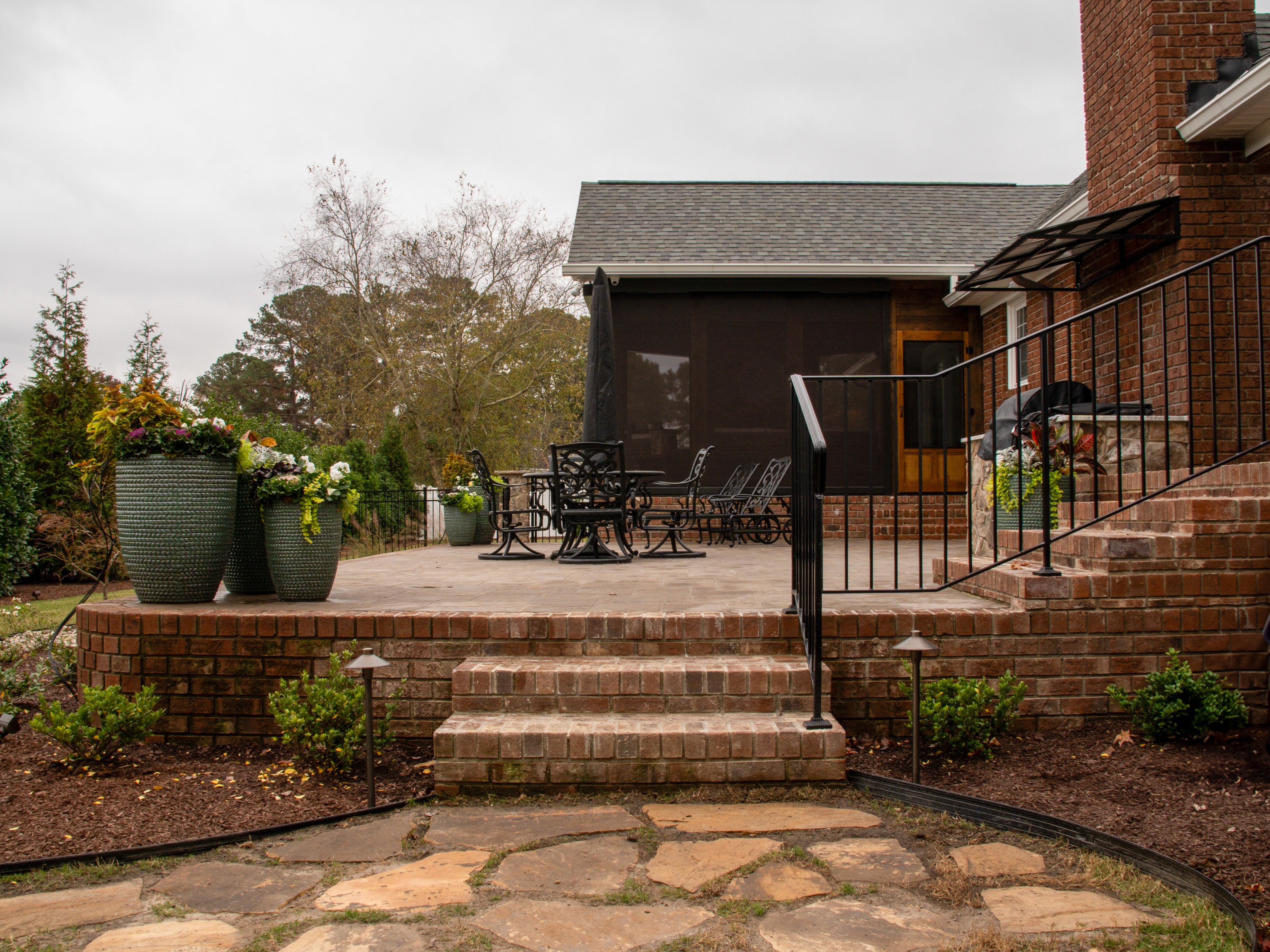 Flagstone steps leading to a paver patio.