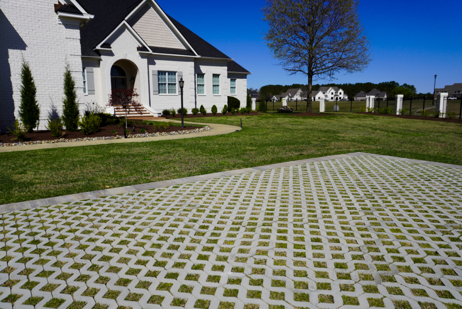 Grass-paver driveway across a front yard.