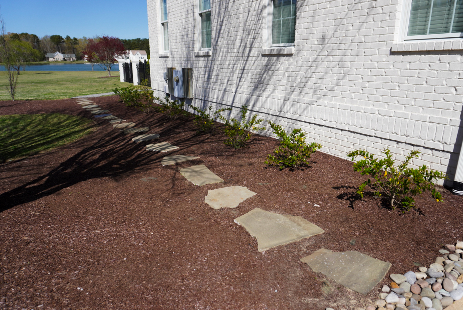 Side stepping-stone walkway near a pond.