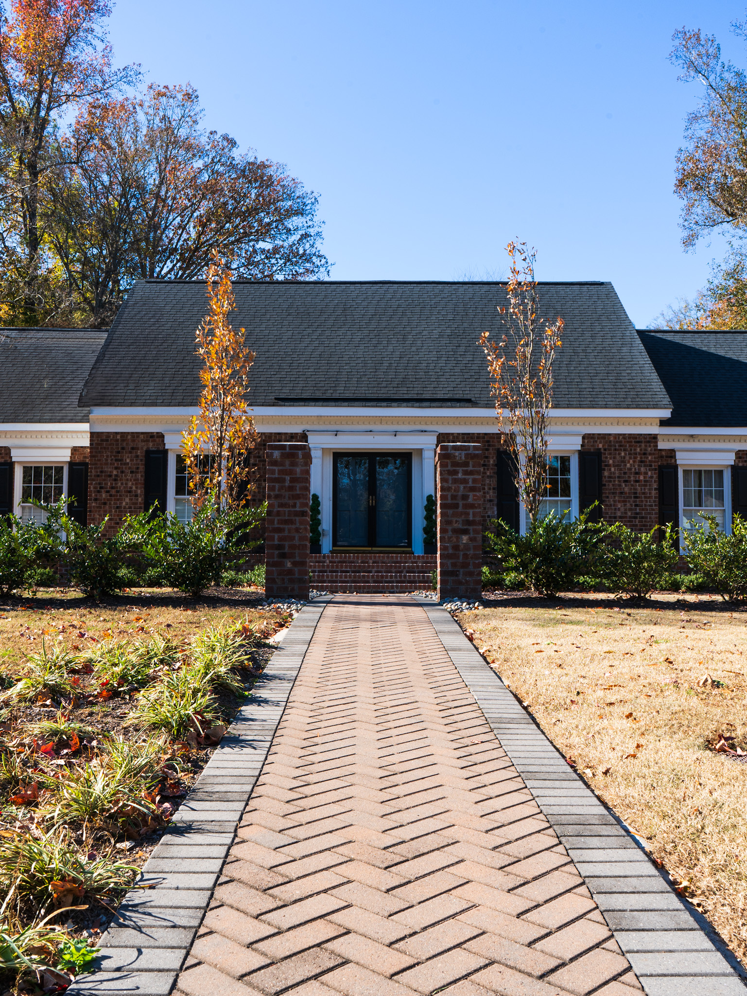 Hand-laid brick walkway leading to a Southern home entry.