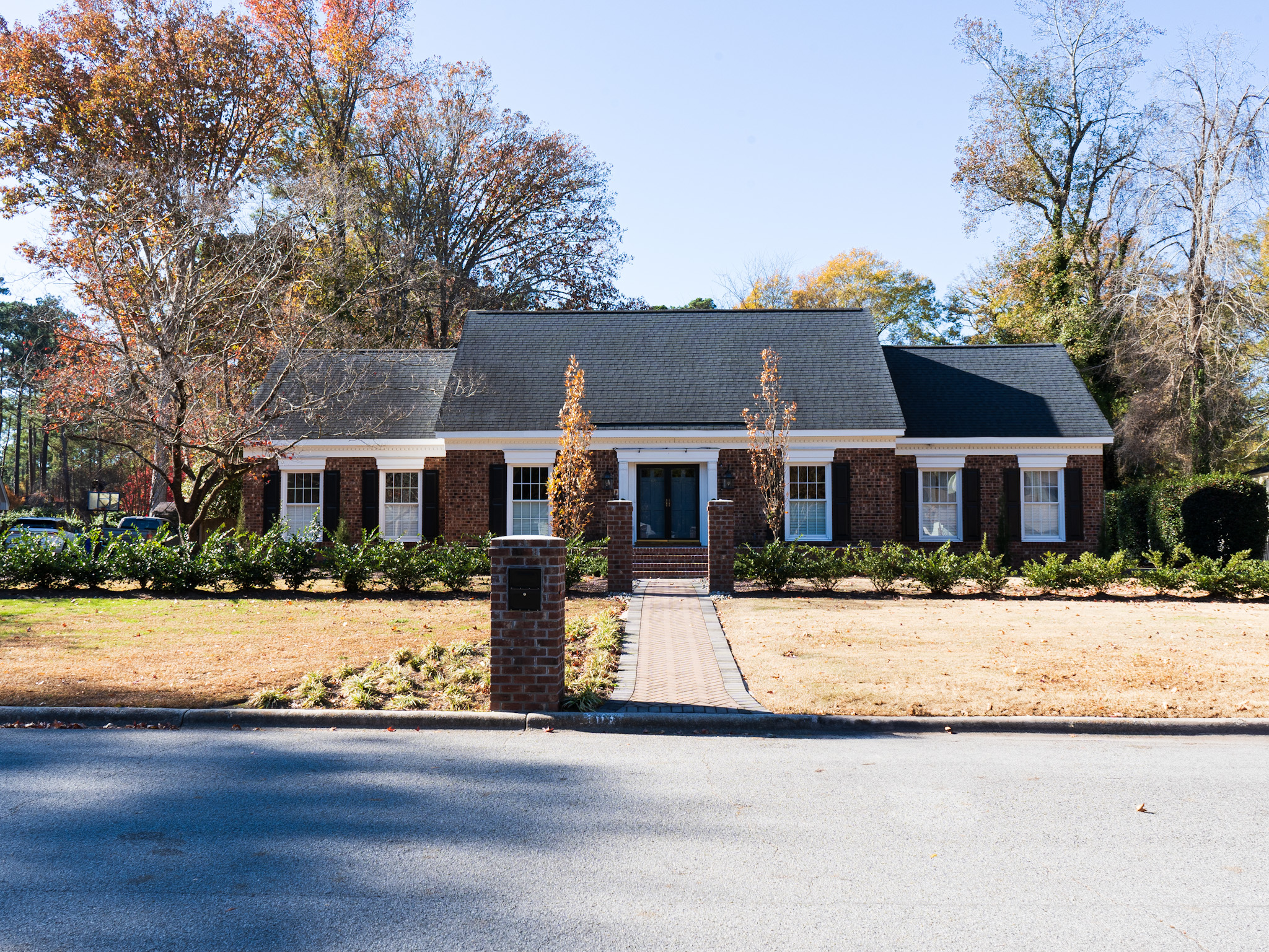 Brick facade with column lighting.