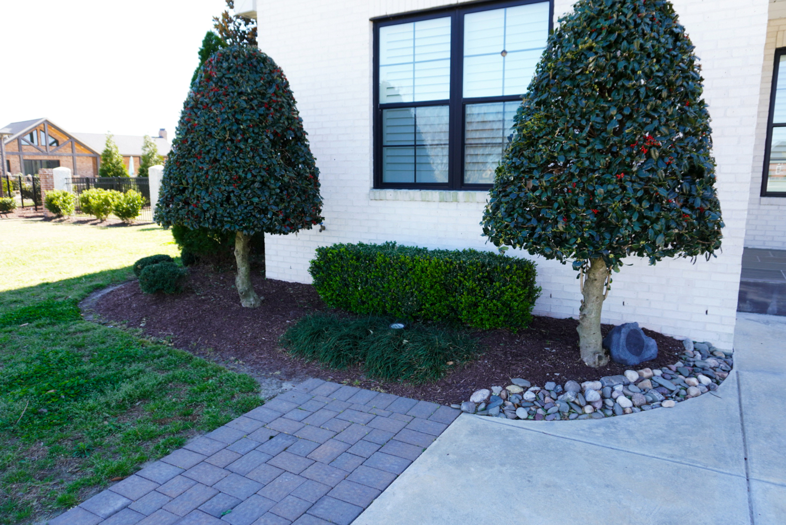 Stone entry pillars with paver walkway.
