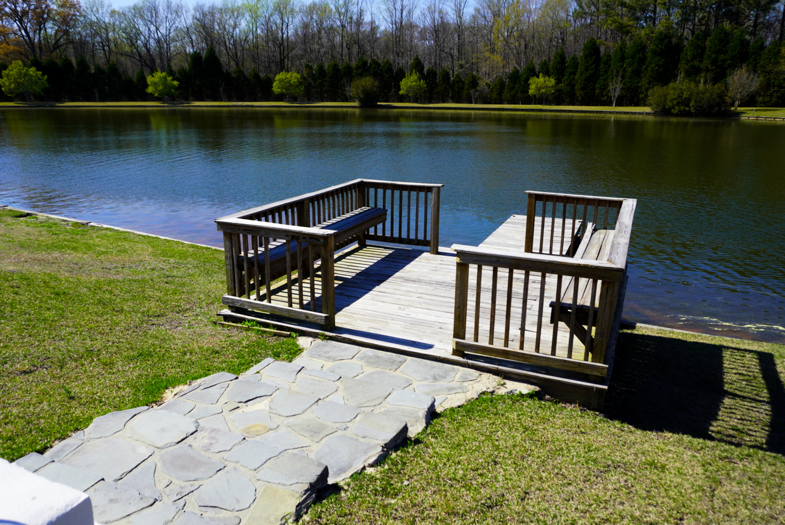 Pond dock with flagstone walkway.