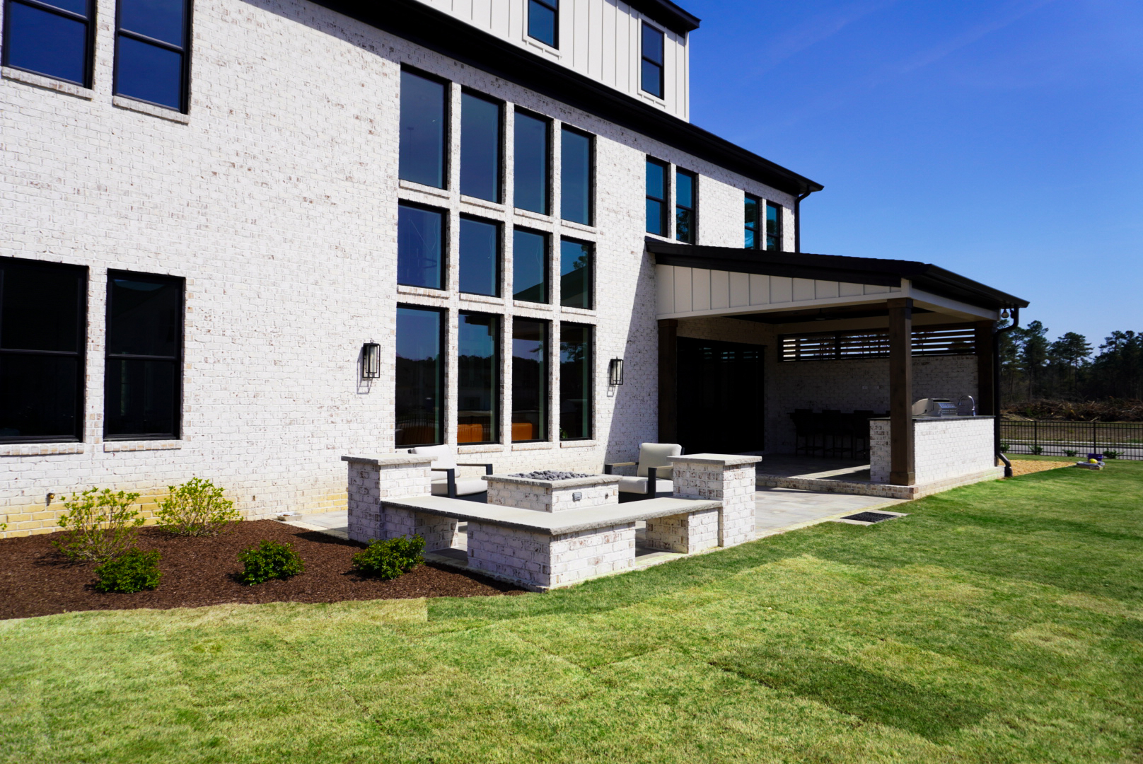 White-brick rear yard with pergola — second angle.