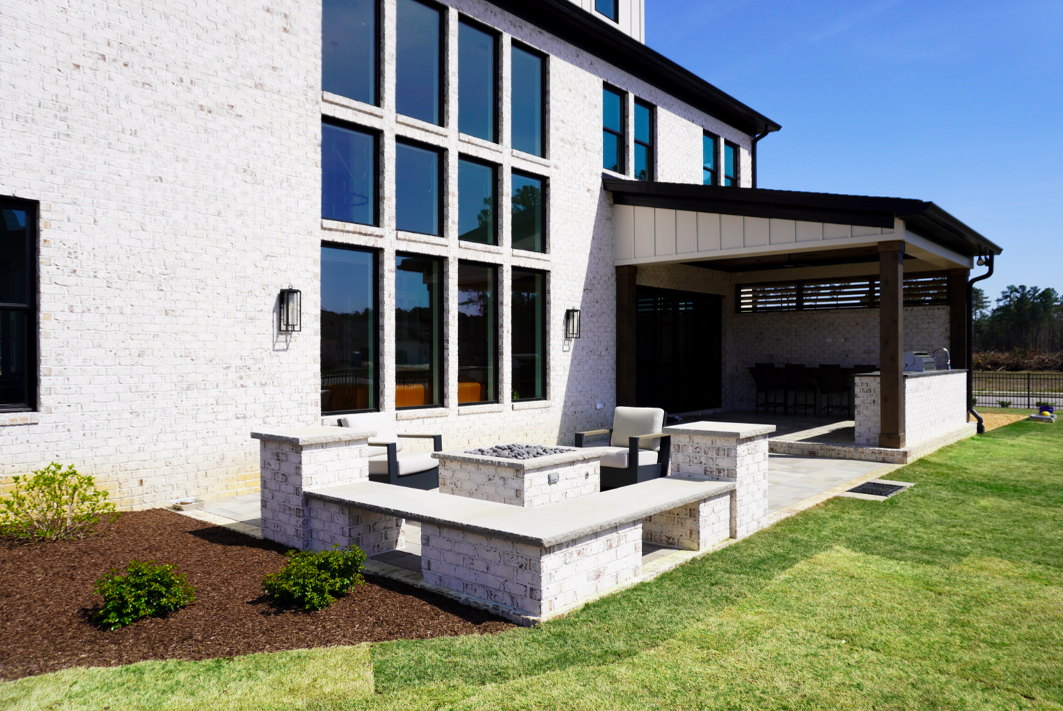 White-brick rear yard with pergola — third angle.