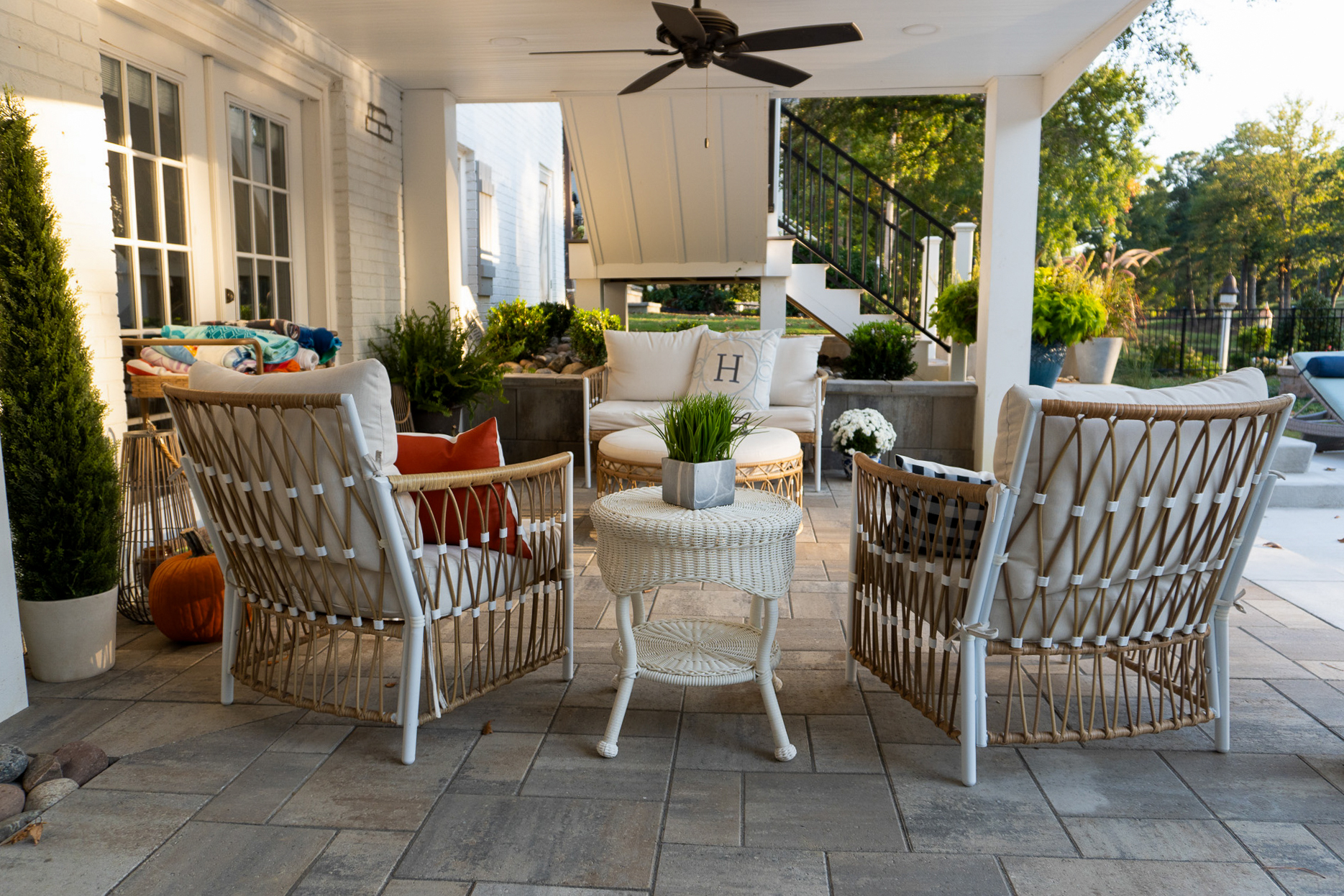 Covered patio with wicker seating.
