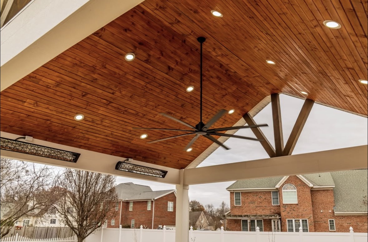 Covered patio with wood ceiling and ceiling fan.