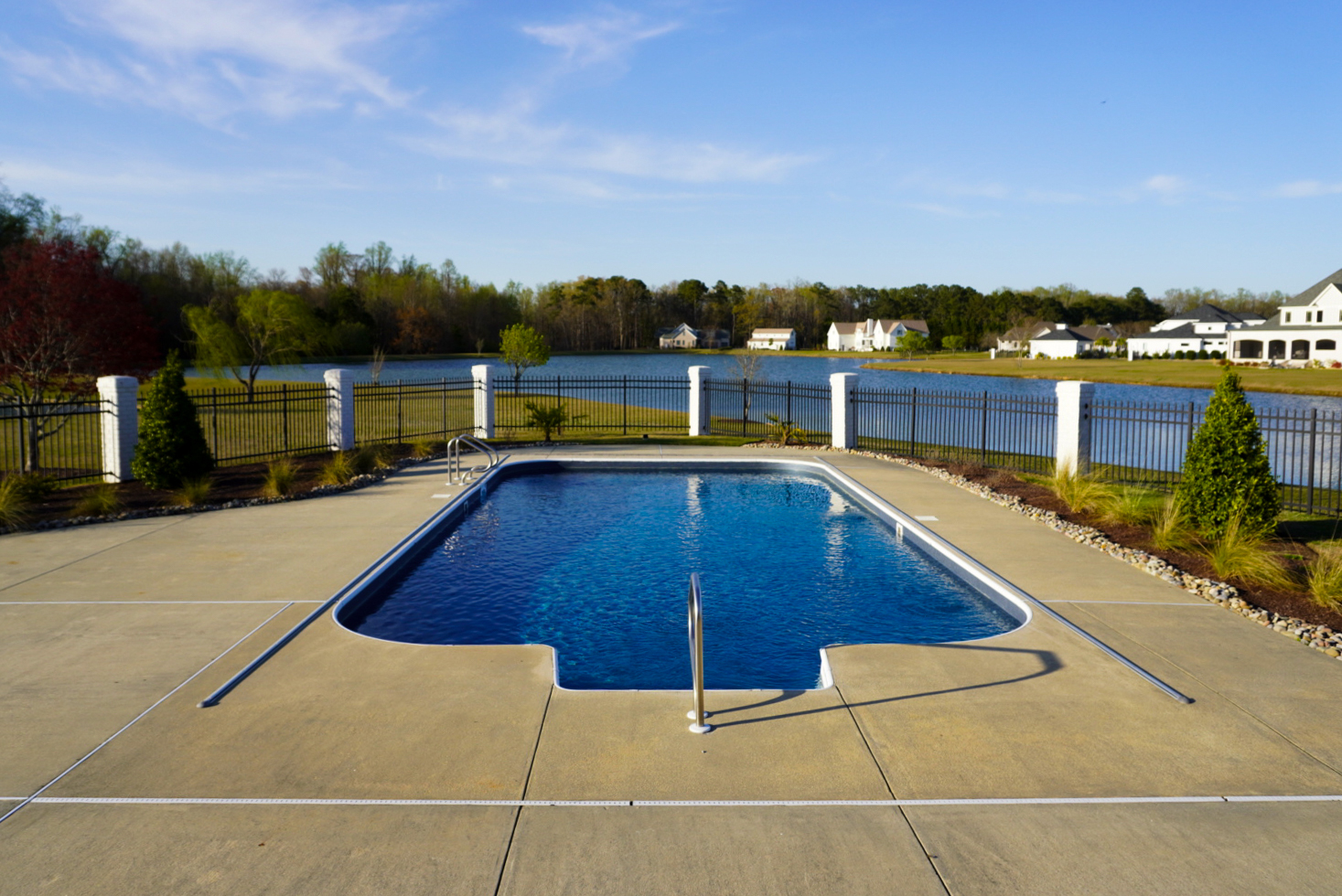 Rectangular pool with pond view.