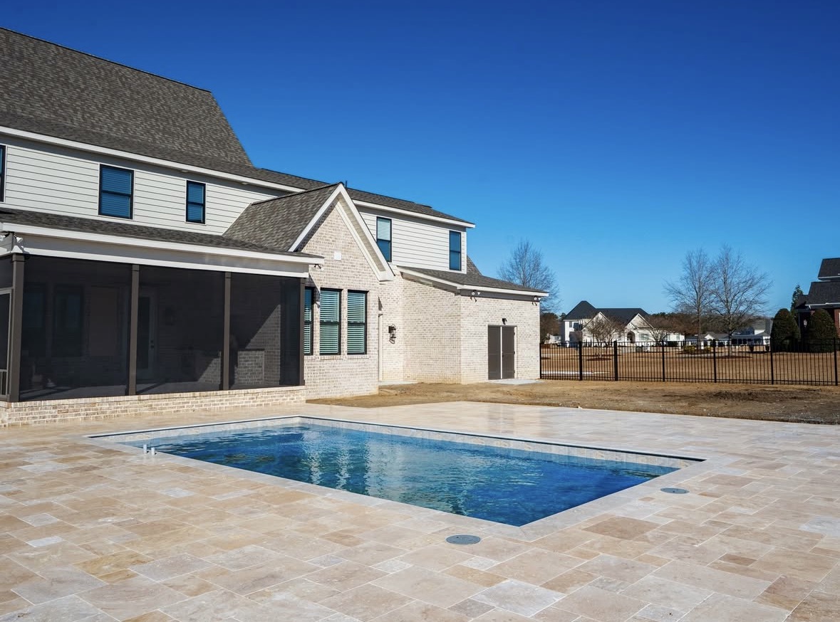 Rectangular pool with travertine deck.